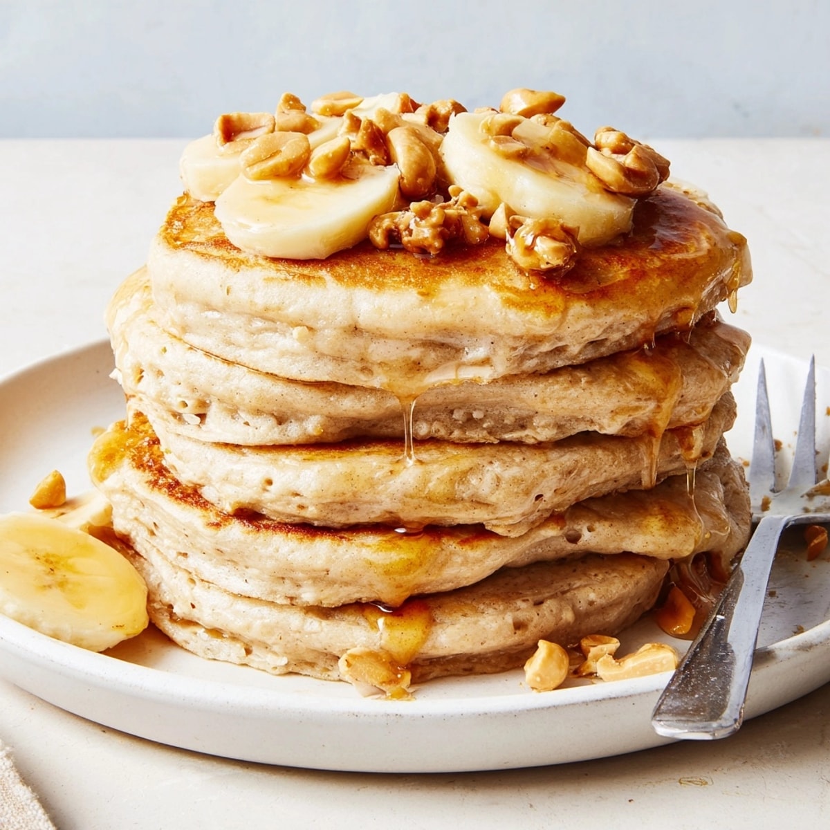 Golden-brown Peanut Butter Maple Oat Pancakes with glistening maple syrup, ready for breakfast.