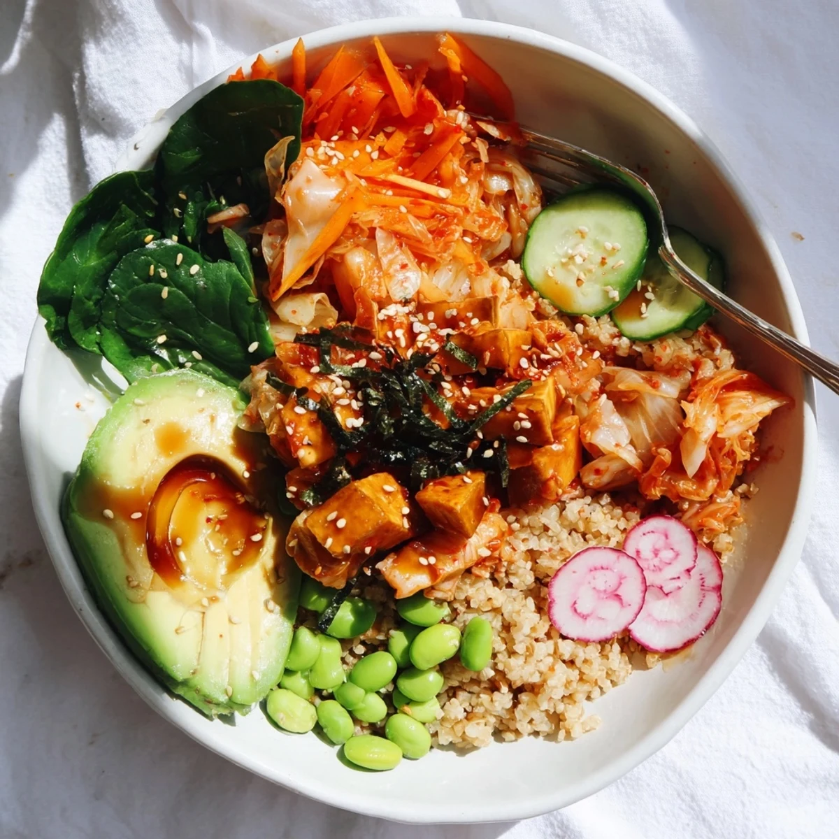 Healthy fermented vegetable bowl topped with creamy avocado and crunchy sesame seeds.