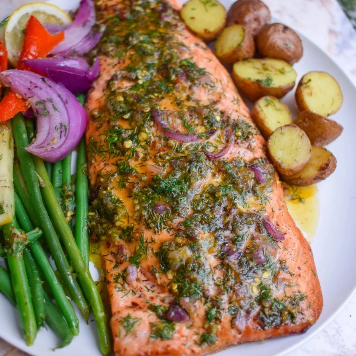 Golden-brown Lemon Herb Salmon & Potato Sheet Pan with flaky salmon and roasted vegetables.
