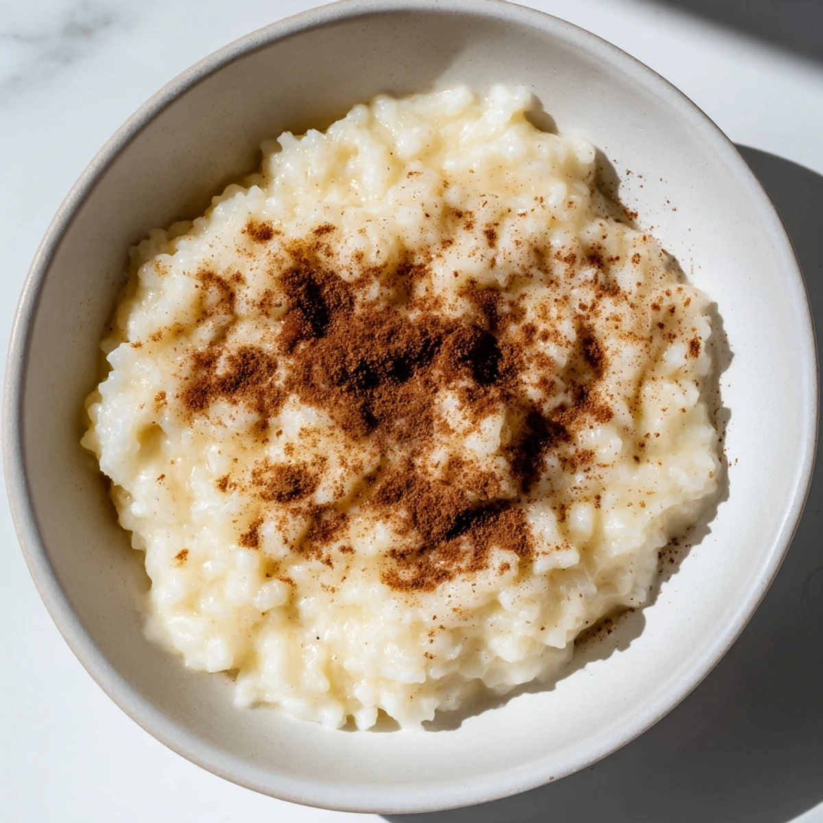 Enjoy a spoonful of rich and flavorful Rice Pudding with Leftover Rice, perfect for dessert.