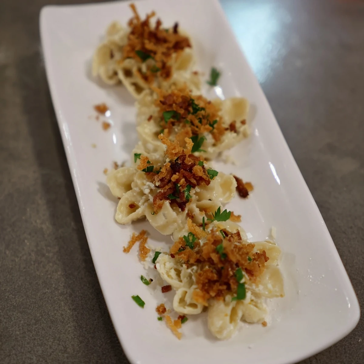 Sheet Pan Mac and Cheese with a golden, bubbly cheese top and crispy bacon crumbles.