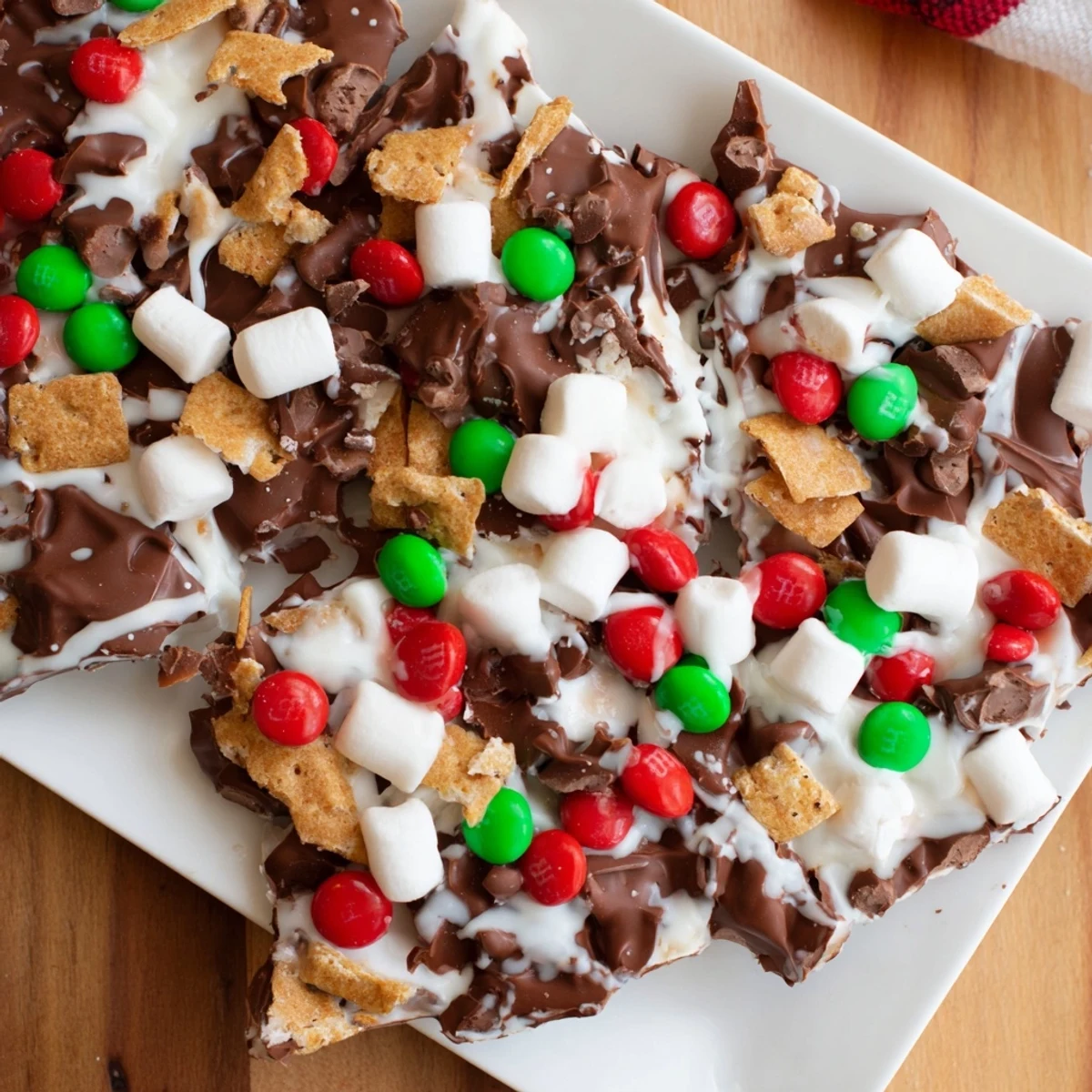 This image shows a close-up of decadent Quick Christmas Smores Bark, a festive holiday dessert, ready to serve.