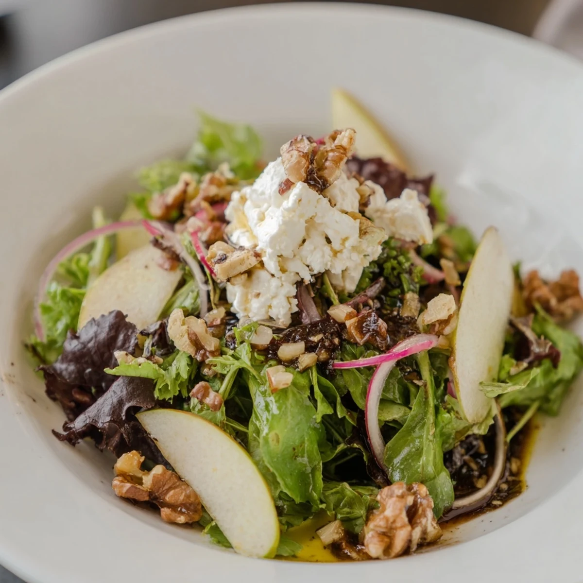Creamy goat cheese and sweet dates star in this Spiced Honey and Date Goat Cheese Salad photo.