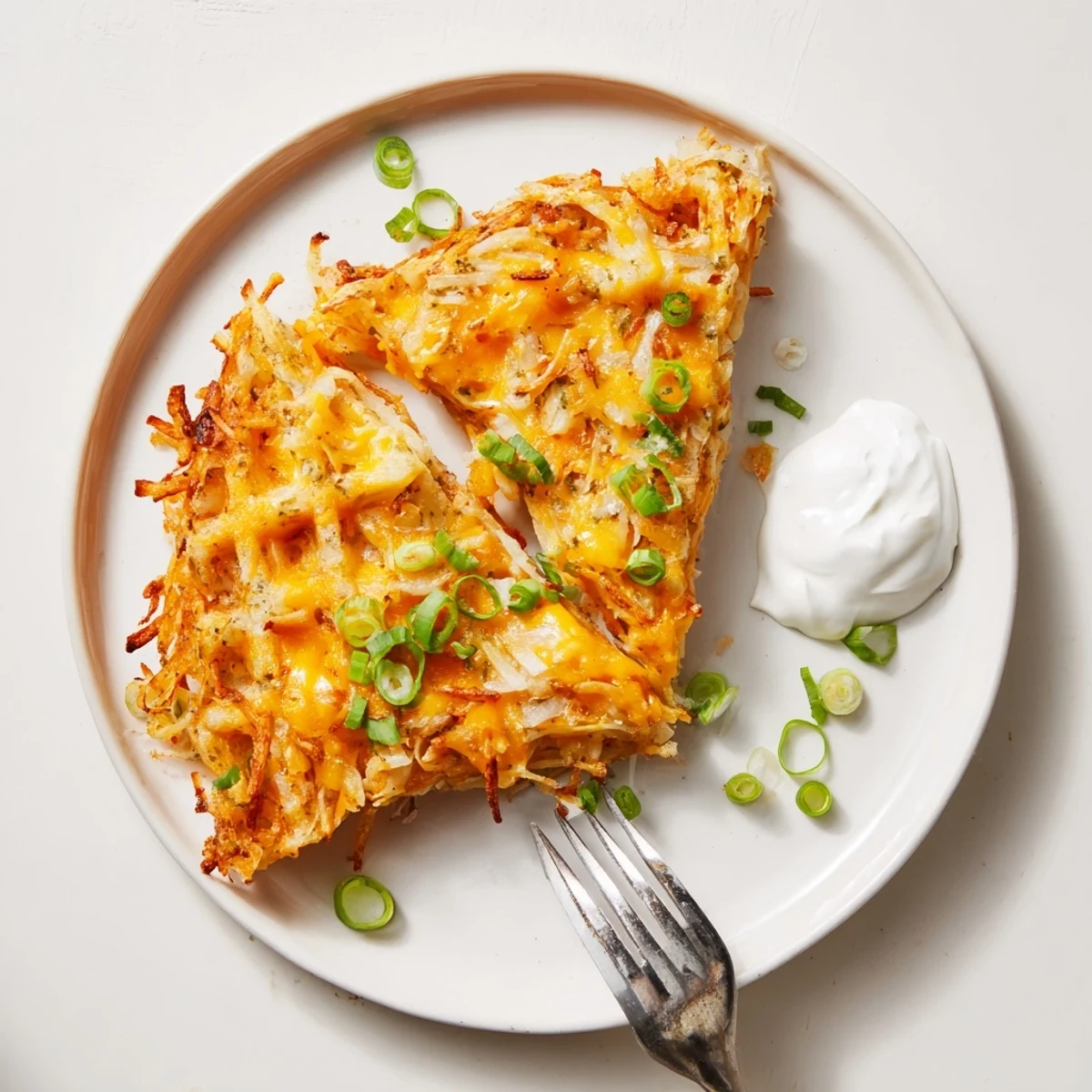Golden-brown and crispy, these cheesy hash brown waffles are loaded with cheddar and savory spices.