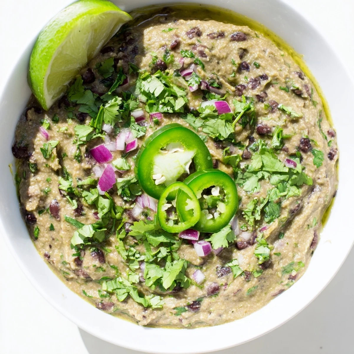 Vibrant Spicy Black Bean Dip served with crunchy tortilla chips, a perfect appetizer for sharing.