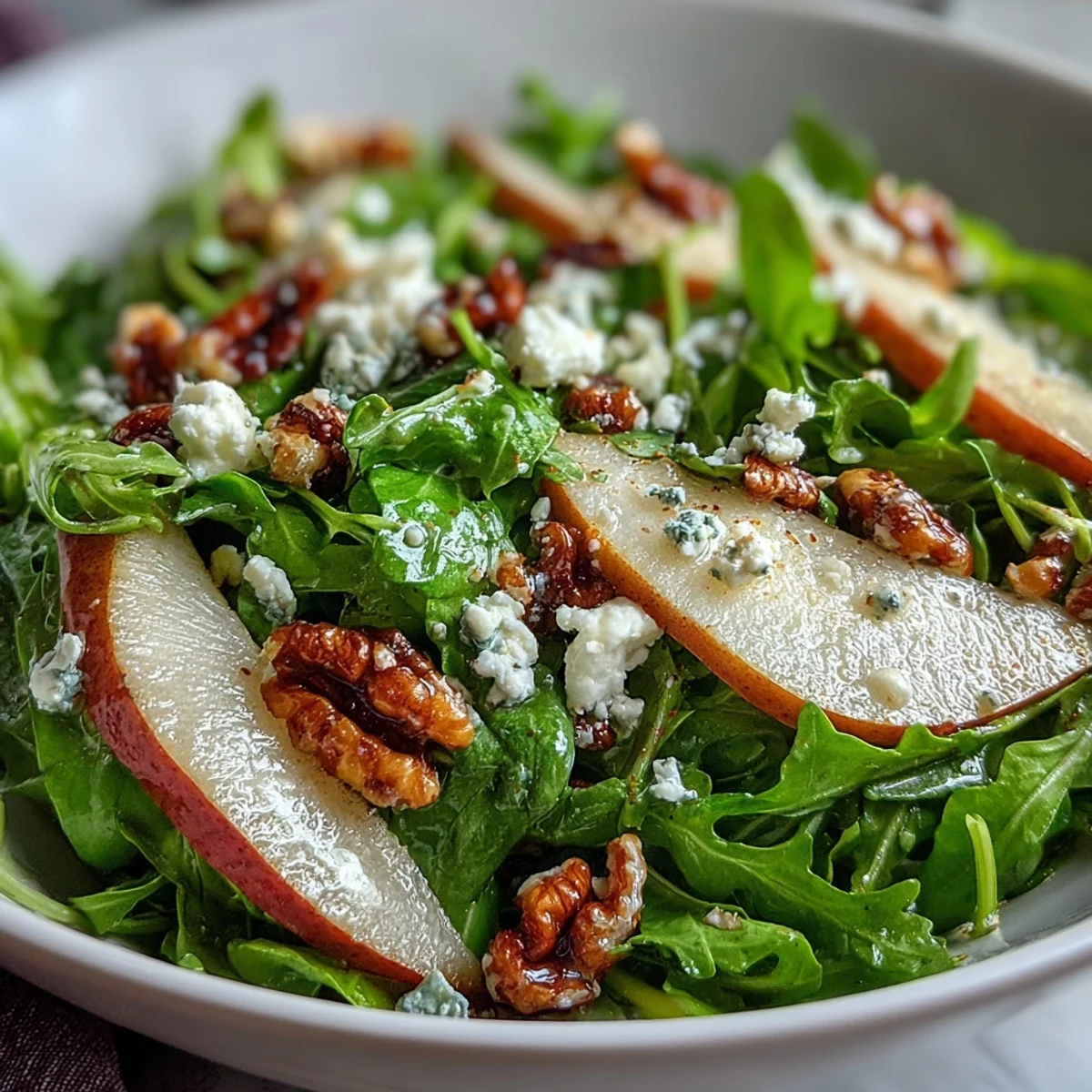 Arugula and Pear Bowl salad with balsamic vinaigrette drizzled over sweet fruit, peppery greens, and crunchy pecans.