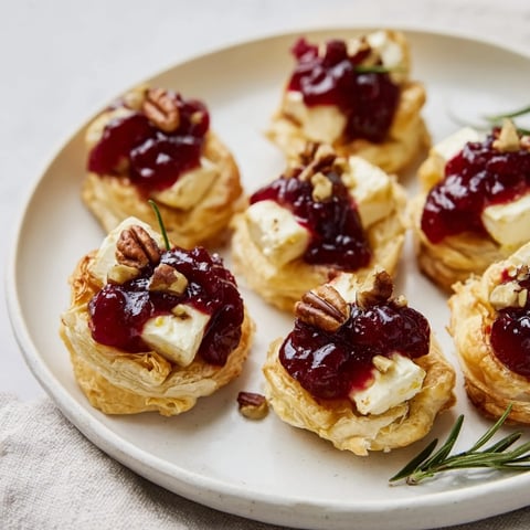 Golden, bubbly Quick Cranberry Brie Bites with melting cheese and vibrant cranberry topping, ready to eat!