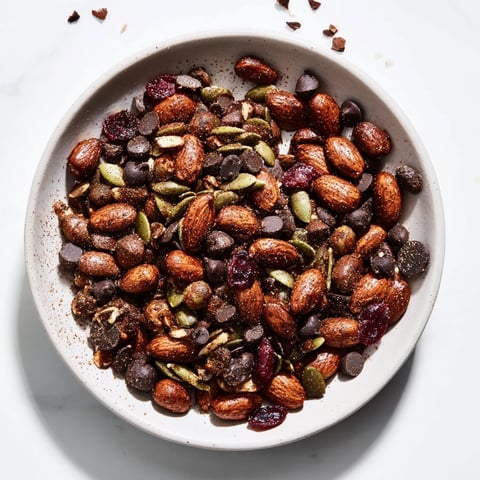 Golden-brown, savory Acorn & Oak Snack Mix with dried cranberries, perfect for snacking.