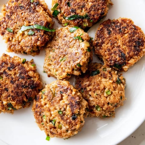 Close-up of freshly fried Garlic Ginger Salmon Patties, a delicious dairy-free seafood dish.