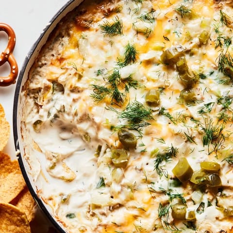 Rich and cheesy dill pickle queso fundido dip, perfect for game day gatherings.  