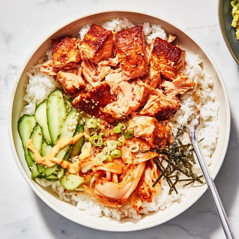 Flavorful Crispy Salmon Rice Bowl featuring golden rice, garlic, and vibrant toppings.  