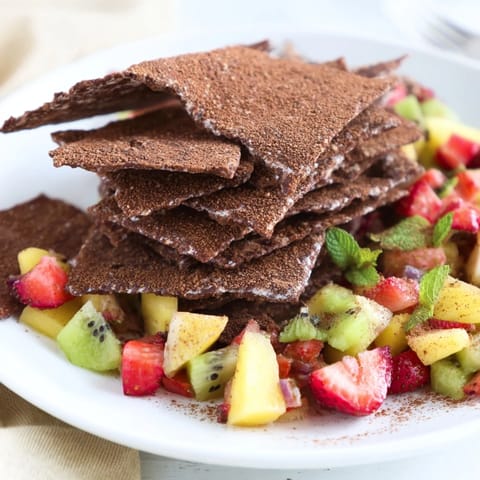 Homemade chocolate tortilla chips elegantly paired with fresh fruit salsa for dipping.  