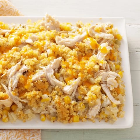 A close-up of a bubbling Southern Cornbread Chicken Casserole with a crispy cornbread crust.