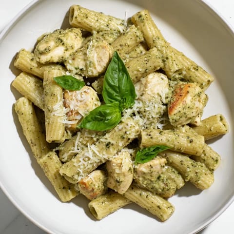 This delicious creamy pesto penne & chicken recipe features golden chicken, al dente penne pasta, and a rich pesto flavor.