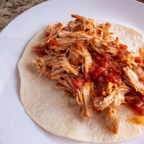 Imagine delicious Crock-Pot Shredded Chicken Tacos piled high with colorful toppings, ready to enjoy at dinner!