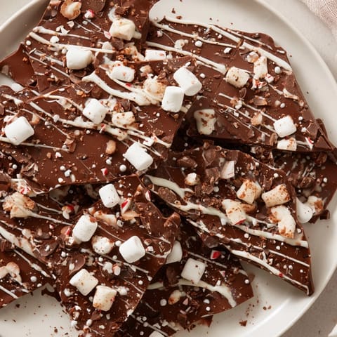 Festive Hot Chocolate Bomb Bark, featuring a swirl of white chocolate, perfect for holiday treats and gifting.