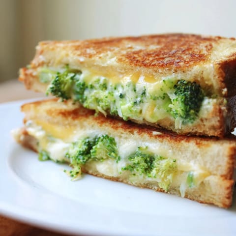 Golden, airy crusts surround melted cheese in this savory Air Fryer Broccoli Cheddar Stuffed Grilled Cheese sandwich.