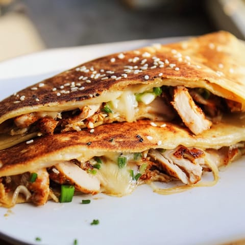 A close-up of a Korean BBQ Chicken Wrap Grilled Cheese, showing the perfectly crisped wrap and melted cheese.