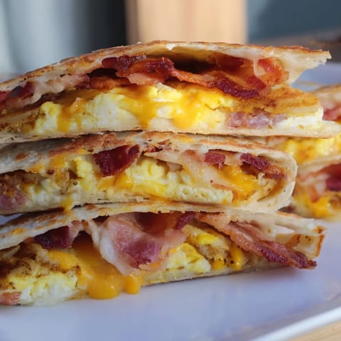 Golden Breakfast Crunchwrap Hack with crispy hash browns, scrambled eggs, and melted cheese, perfect for breakfast.