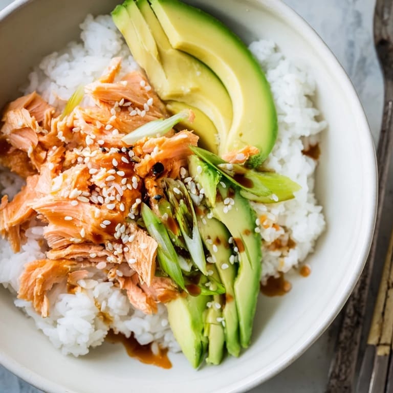 Quick and easy leftover salmon & rice bowl bursting with vibrant toppings and flavor.  