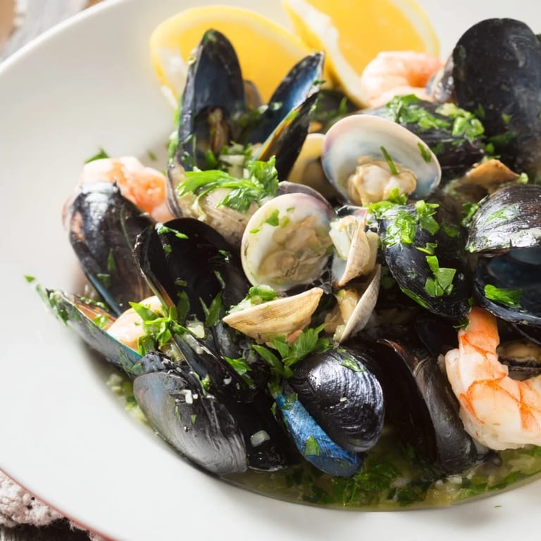 Freshly cooked Shellfish & Seafood Medley arranged with parsley, ready for a delightful and fragrant dinner.