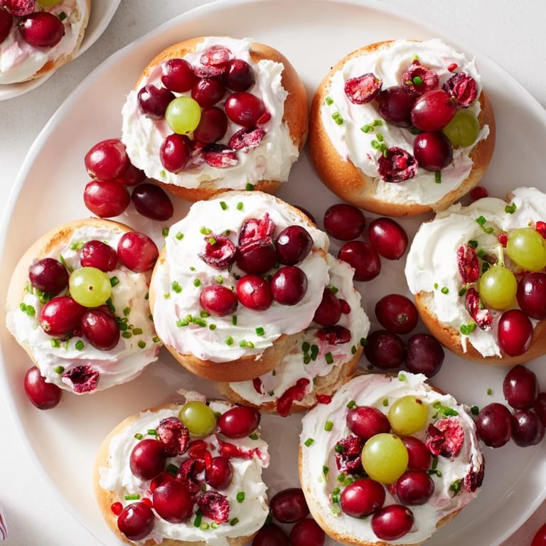 Vibrant and shareable Cranberry Sleigh Bagel Board, piled high with bagels, cream cheese, and garnishes perfect for brunch.