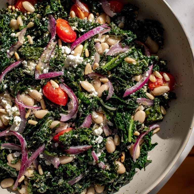 A close-up of the White Bean and Kale Salad showing red onion slices and optional feta, perfect for a healthy Mediterranean lunch.