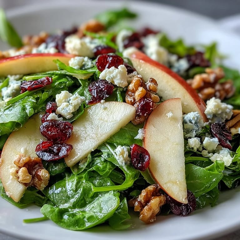 Crisp greens and apples paired with walnuts and goat cheese in a Mixed Greens and Apple Bowl, drizzled with homemade cider vinaigrette.